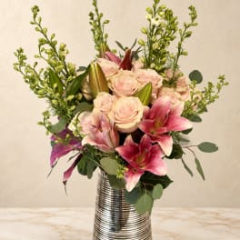 Pink roses and lilies in a silver striped vase