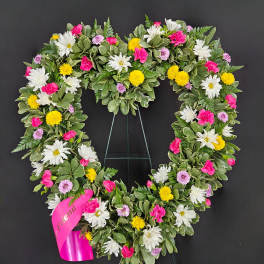 Heart-shaped floral wreath with white, pink, and yellow flowers