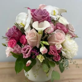 Pink and white floral arrangement in a white vase