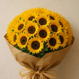 Bouquet of bright yellow sunflowers wrapped in brown paper