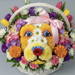 Flower basket arranged as a dog face with a pink ribbon bow