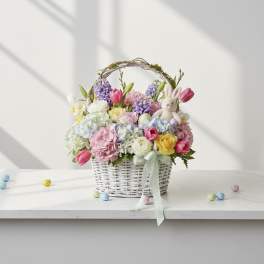 Pastel flower basket with a plush bunny and ribbon