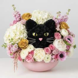 Cat-shaped floral arrangement in a pink bowl with roses and hydrangeas