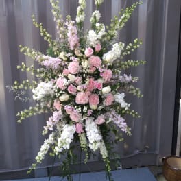 Tall pink and white floral standing spray on an easel