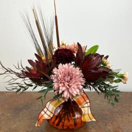 Autumn bouquet with pink and burgundy flowers in an amber vase
