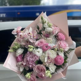 Pink and white mixed bouquet wrapped in pale pink paper