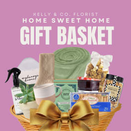 Gift basket with snacks, a mug, a succulent, and home items