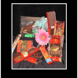 Gift basket with chocolates and a pink daisy