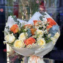 Bouquet of orange and white roses with small white daisies