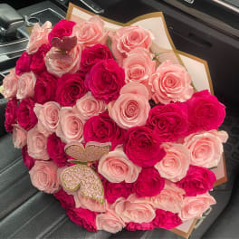 Bouquet of pink and hot pink roses with butterfly picks
