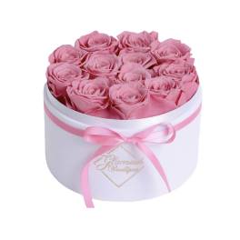 Pink roses arranged in a white round box with a pink ribbon