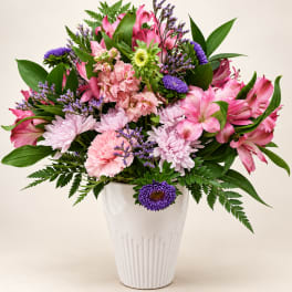 Pink and purple mixed bouquet in a white vase
