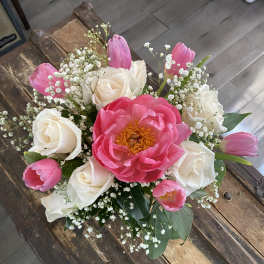 Bouquet of pink tulips, white roses, and a large pink peony