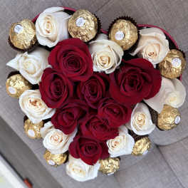 Heart-shaped bouquet of red and white roses with gold-wrapped chocolates