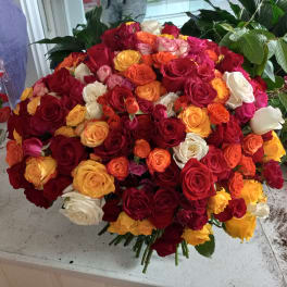 Large bouquet of multicolored roses in red, pink, yellow, orange, and white
