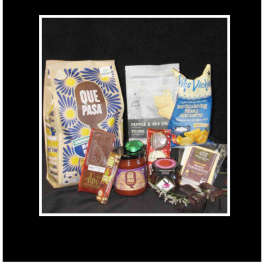 Assorted snack and chocolate gift items arranged on a dark background