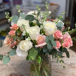 White and pink roses in a clear glass vase
