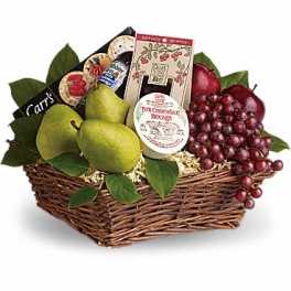 Fruit basket with pears, grapes, and packaged snacks in a wicker basket