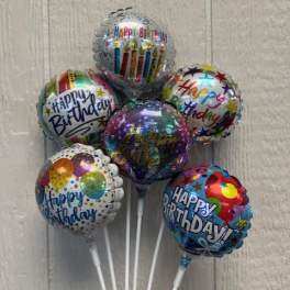 Cluster of birthday balloons with colorful printed designs