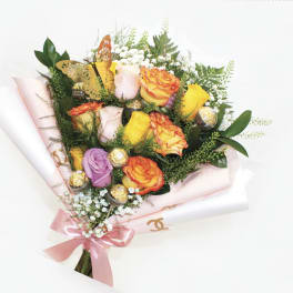 Bouquet of multicolored roses with a pink ribbon and gold butterfly decoration