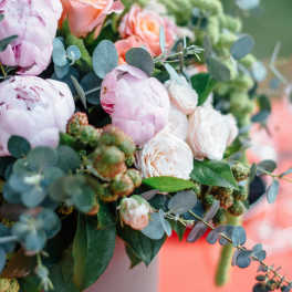 Pink and peach roses with pale peonies in a vase