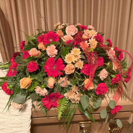 Large casket spray with pink and peach flowers