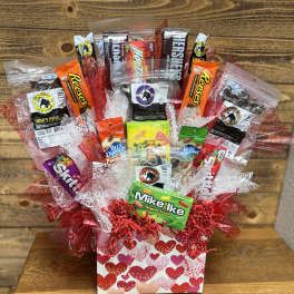 Gift basket of assorted candy and jerky in a heart-patterned box