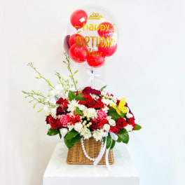 Red and white flower basket with a birthday balloon