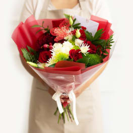 Bouquet of red and white flowers wrapped in red paper