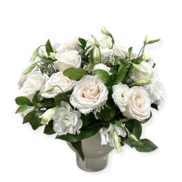 White and blush roses arranged in a gray vase