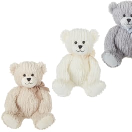 Three plush teddy bears in cream, white, and gray with ribbons