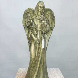 Angel statue holding a bird and flowers