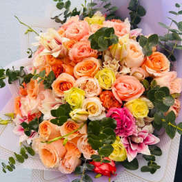 Bouquet of peach, pink, and yellow roses with eucalyptus