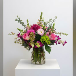 Pink and purple mixed bouquet in a clear glass vase