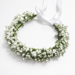White floral wreath with a satin ribbon bow