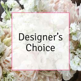 White and blush floral arrangement with a "Designer’s Choice" label