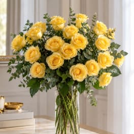 Yellow roses arranged in a clear glass vase