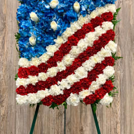 Patriotic floral easel spray with blue, white, and red flowers