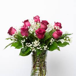 Pink roses and baby's breath in a clear glass vase