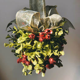 Decorative holiday greenery with red berries and a metallic bow