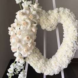 White floral wreath and cascading bouquet on a stand