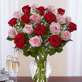 Bouquet of red and pink roses in a clear glass vase
