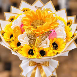 Bouquet of yellow sunflowers and white satin flowers with gold ribbon