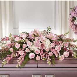 Pink floral casket spray with roses and lilies