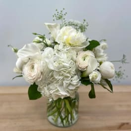 White floral bouquet in a clear glass vase