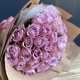Bouquet of lavender roses wrapped in brown paper