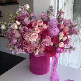 Pink and purple rose bouquet in a magenta box with ribbon