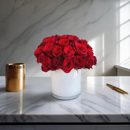 Red rose bouquet in a white vase on a marble table