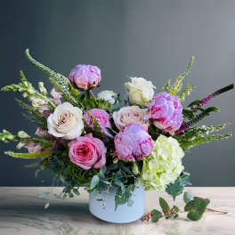 Pink and white roses with hydrangea in a white vase