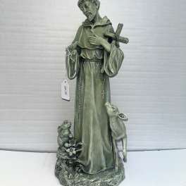 Green religious statue of a saint with a cross and two animals at the base